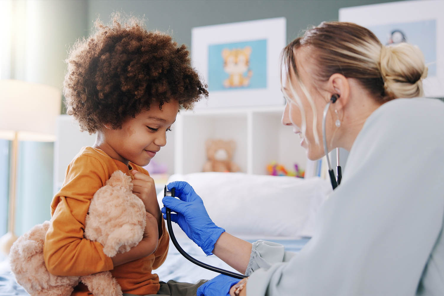 a female doctor using a stethoscope on a child patient - to represent child safeguarding